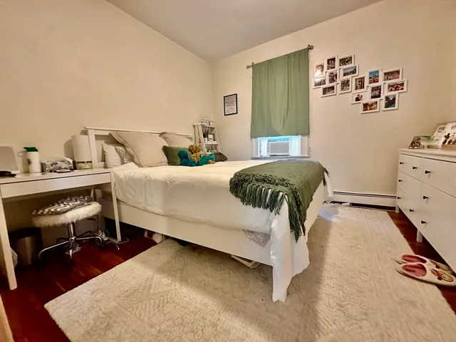 a bedroom with a bed and lamp