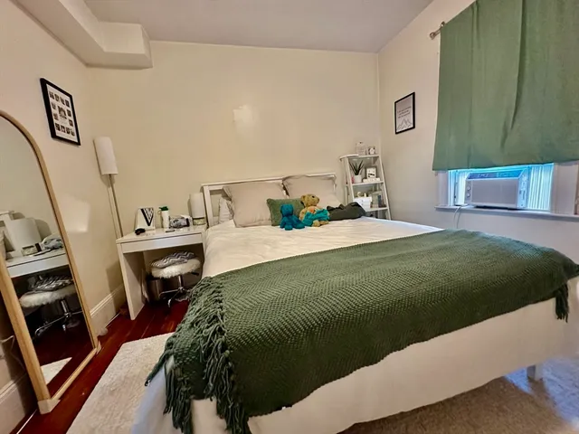 a bedroom with a bed next to a window with the outer view