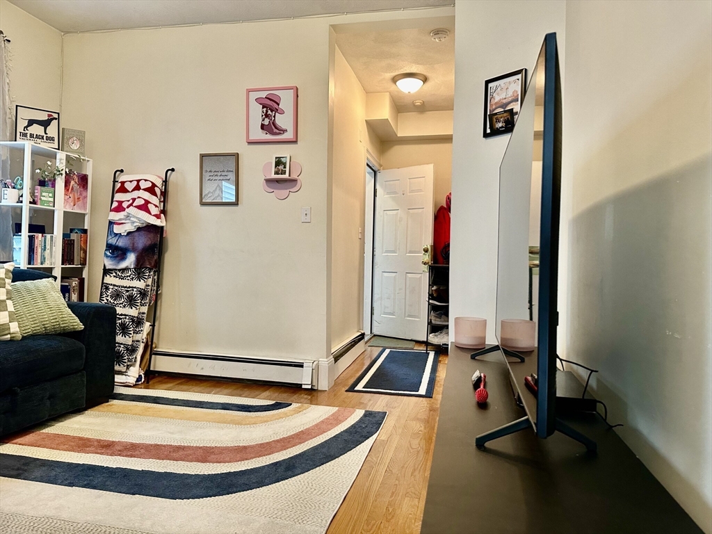 12-14 Marcella Street, Unit 2 Cambridge, MA 02141 - Photo 5 of 23 a room with gym equipment and a mirror