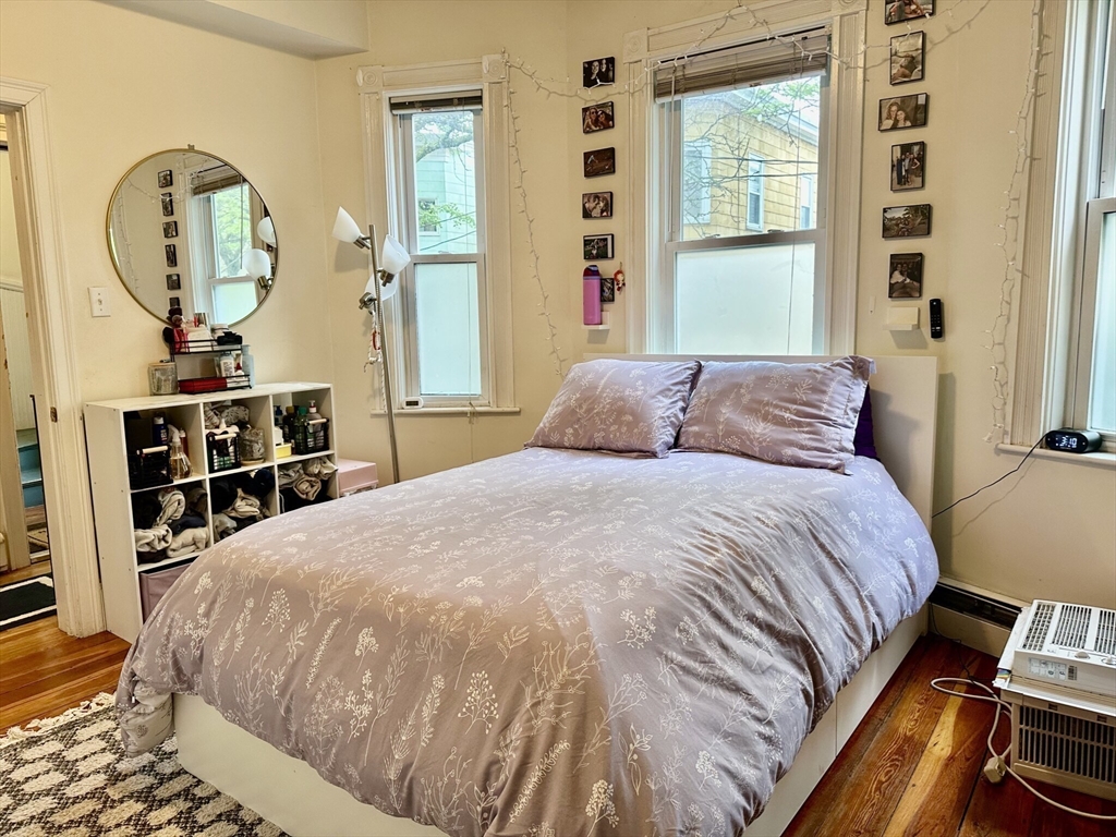 12-14 Marcella Street, Unit 2 Cambridge, MA 02141 - Photo 9 of 23 a bedroom with a bed and wooden floor