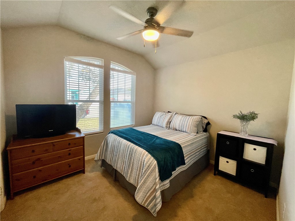 103 Sandollar Circle Fulton, TX 78382 - Photo 16 of 25 a spacious bedroom with a bed and a chandelier