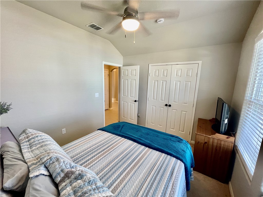 103 Sandollar Circle Fulton, TX 78382 - Photo 17 of 25 a bedroom with a bed and a chandelier