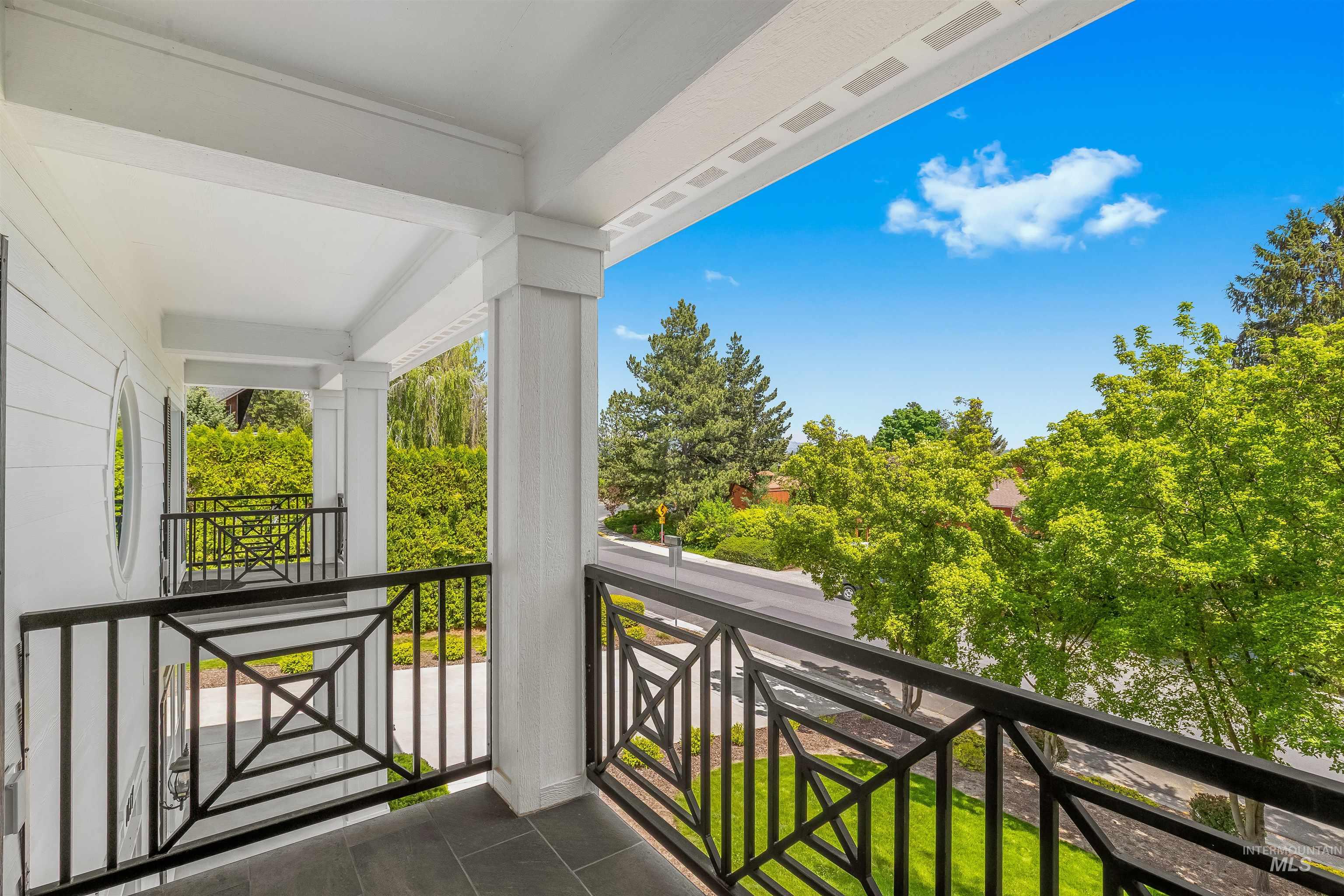 1617 Pine Cone Road Moscow, ID 83843 - Photo 25 of 44 Covered balcony featuring dark tile flooring and decorative black iron railings