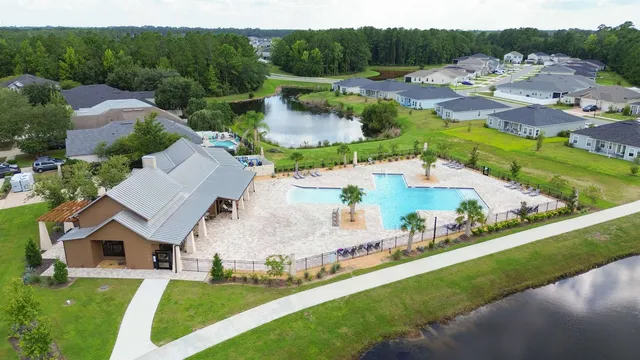 a view of a swimming pool with a garden and trees