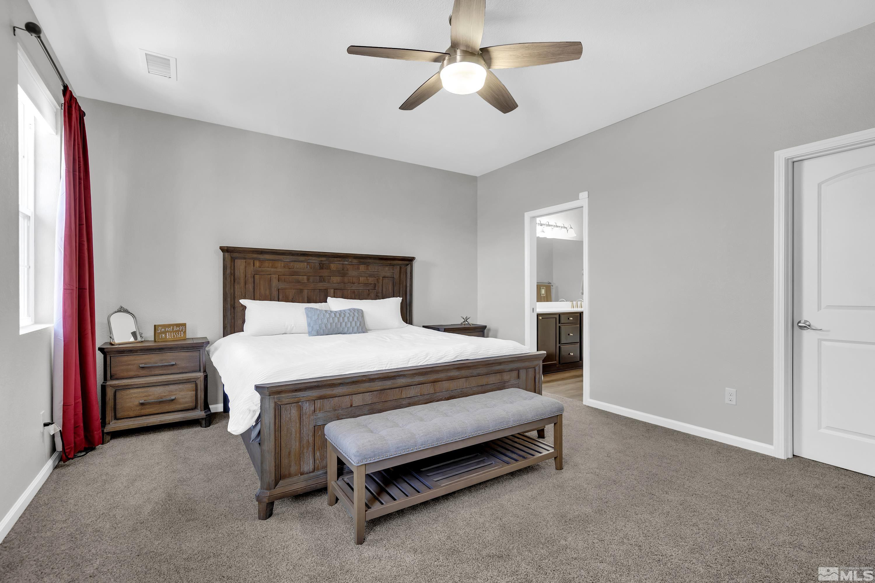 2255 Makenna Drive Reno, NV 89521 - Photo 12 of 34 a bedroom with a bed and a chandelier