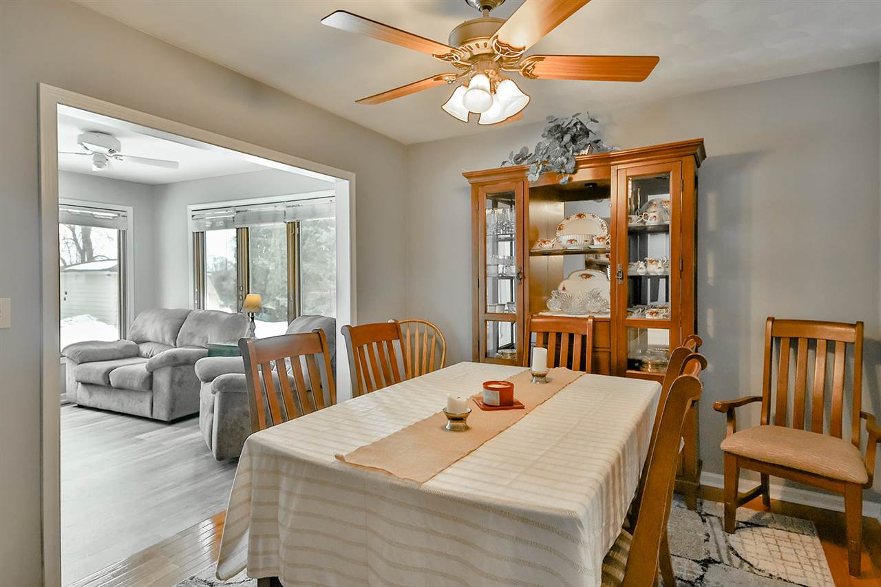 8112 McCurry Road Roscoe, IL 61073 - Photo 12 of 30 a view of a a dining room with furniture window and wooden floor