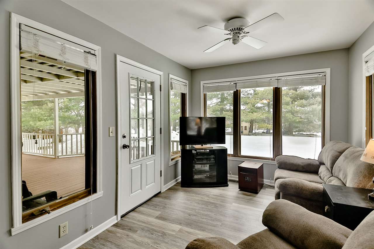 8112 McCurry Road Roscoe, IL 61073 - Photo 14 of 30 a living room with furniture tv and a fireplace