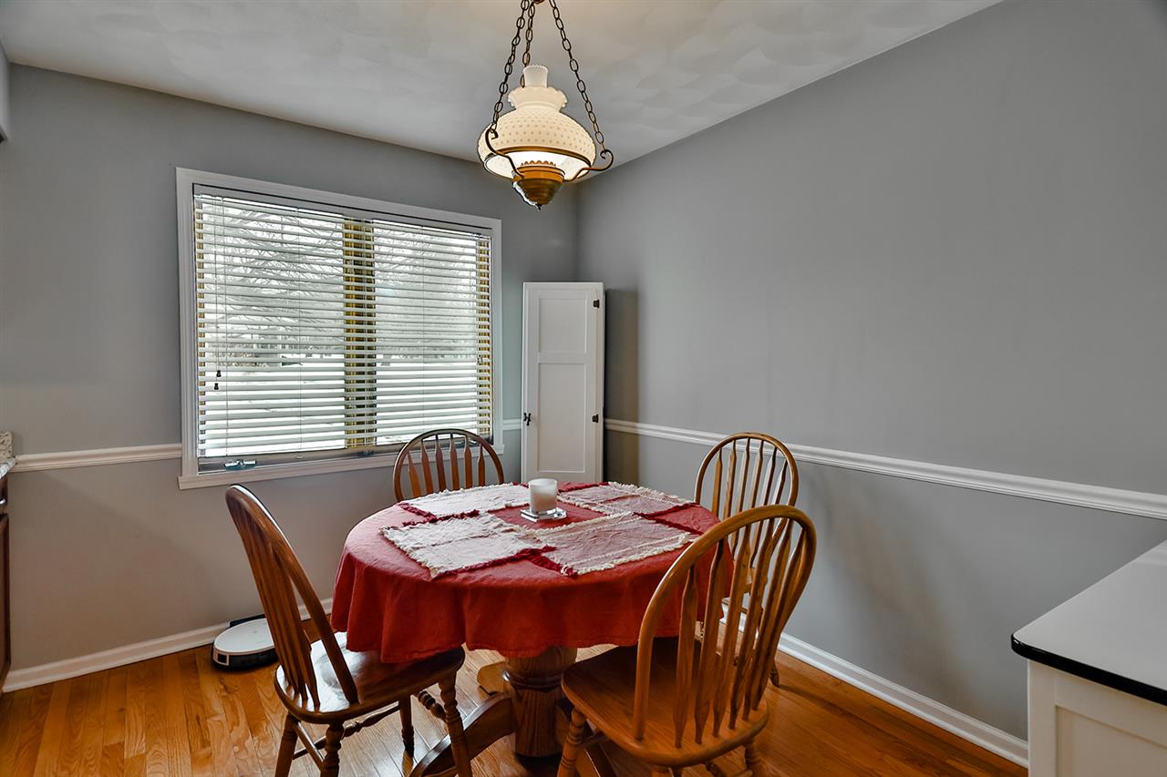 8112 McCurry Road Roscoe, IL 61073 - Photo 15 of 30 a view of a dining room with furniture window and wooden floor