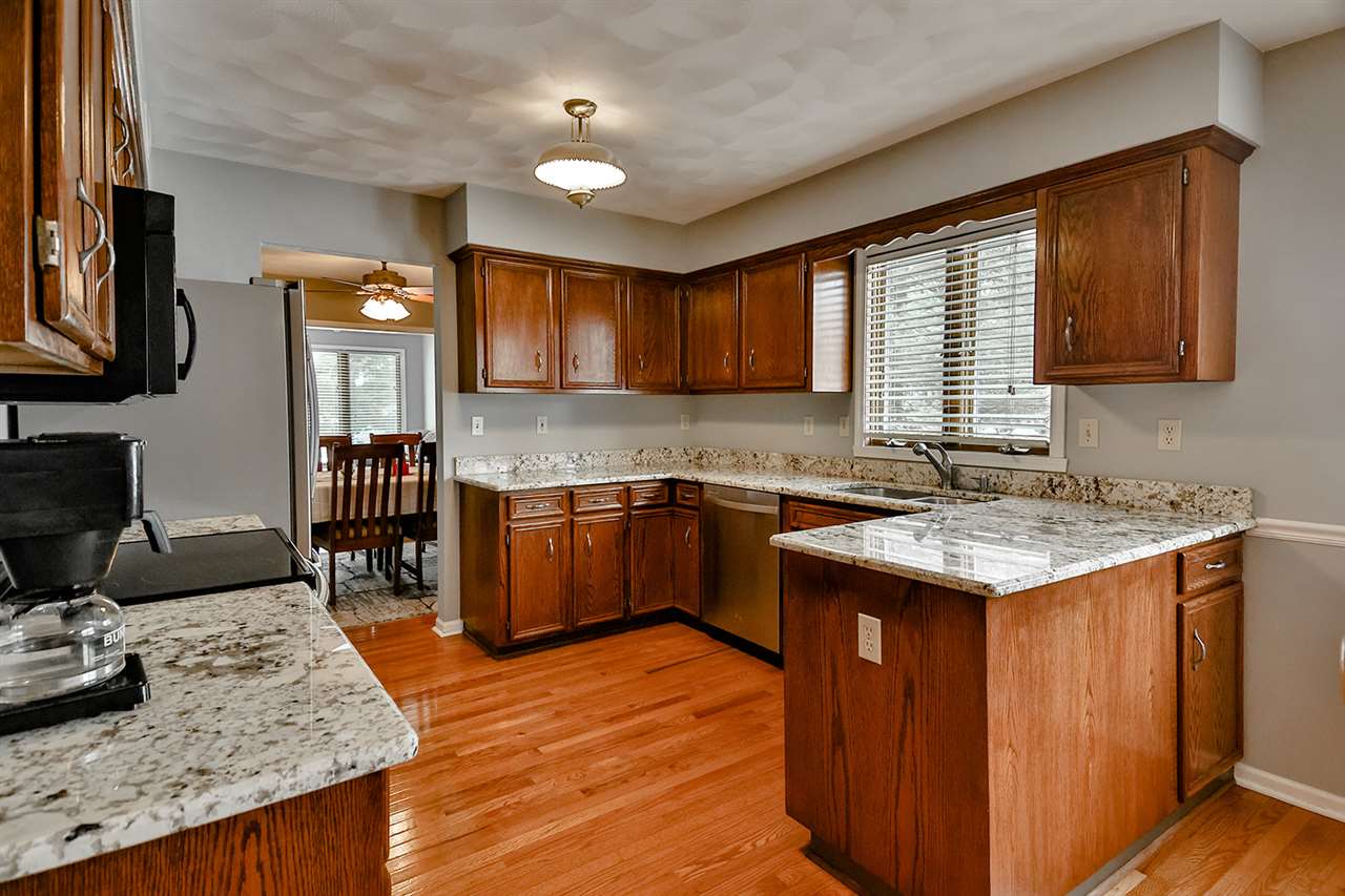 8112 McCurry Road Roscoe, IL 61073 - Photo 17 of 30 a kitchen with granite countertop a sink stove and cabinets