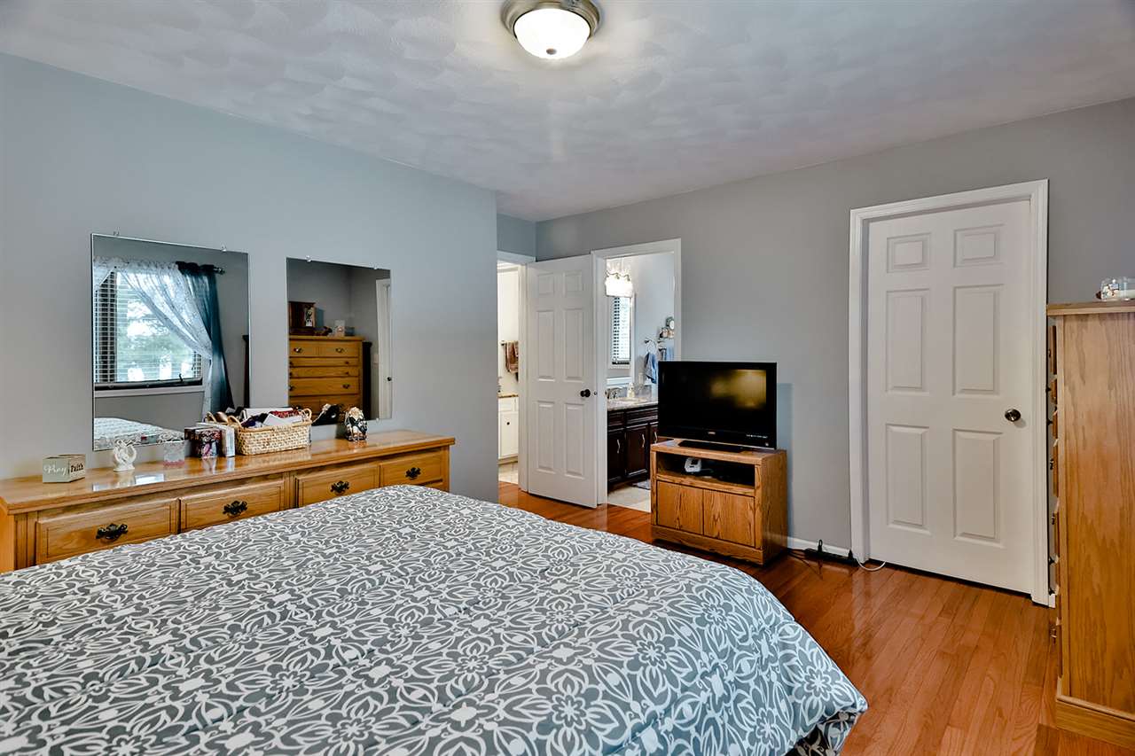 8112 McCurry Road Roscoe, IL 61073 - Photo 26 of 30 a bedroom with a bed and a flat screen tv