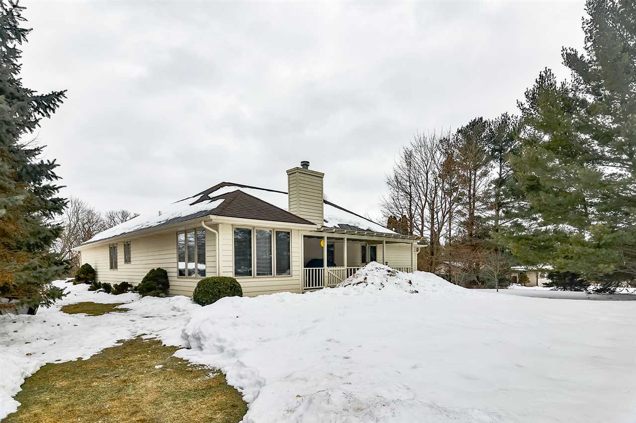 8112 McCurry Road Roscoe, IL 61073 - Photo 3 of 30 a view of a house with a yard covered in snow