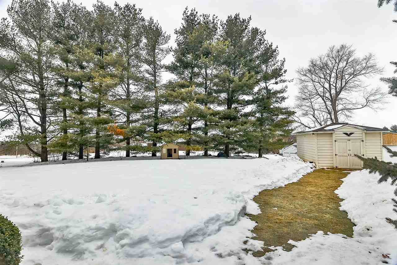 8112 McCurry Road Roscoe, IL 61073 - Photo 5 of 30 a view of a yard covered in snow