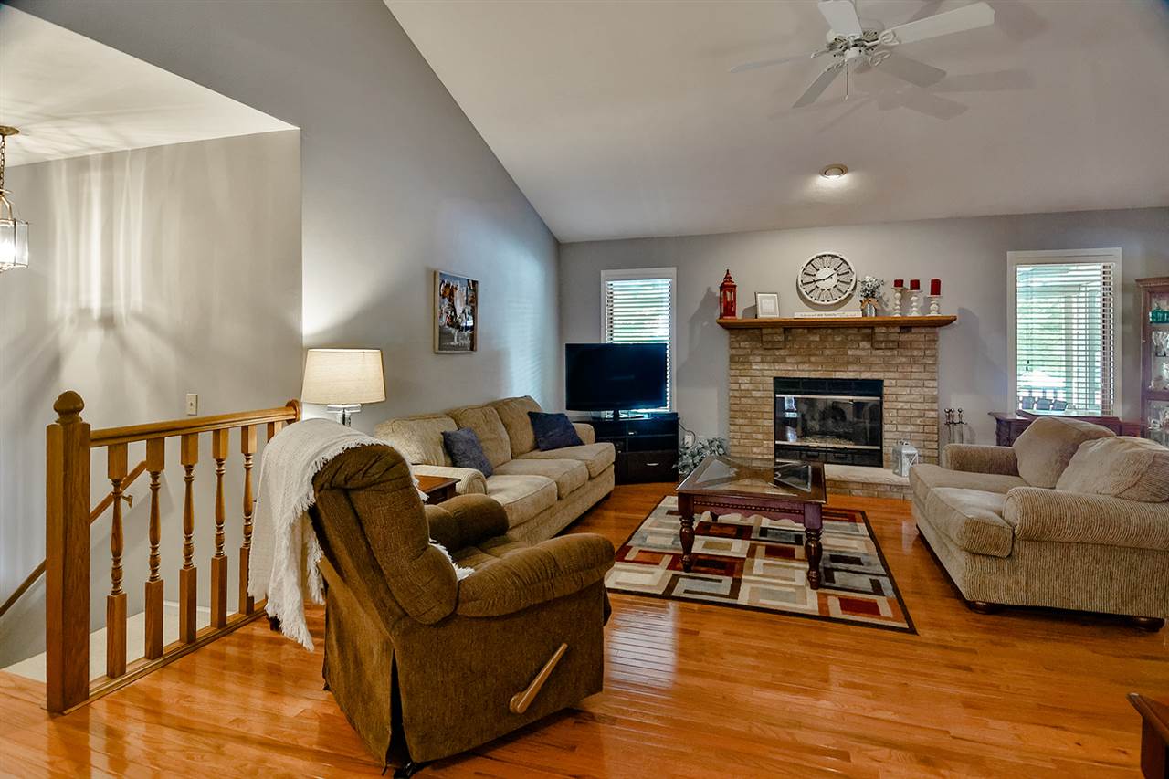 8112 McCurry Road Roscoe, IL 61073 - Photo 8 of 30 a living room with furniture and a fireplace