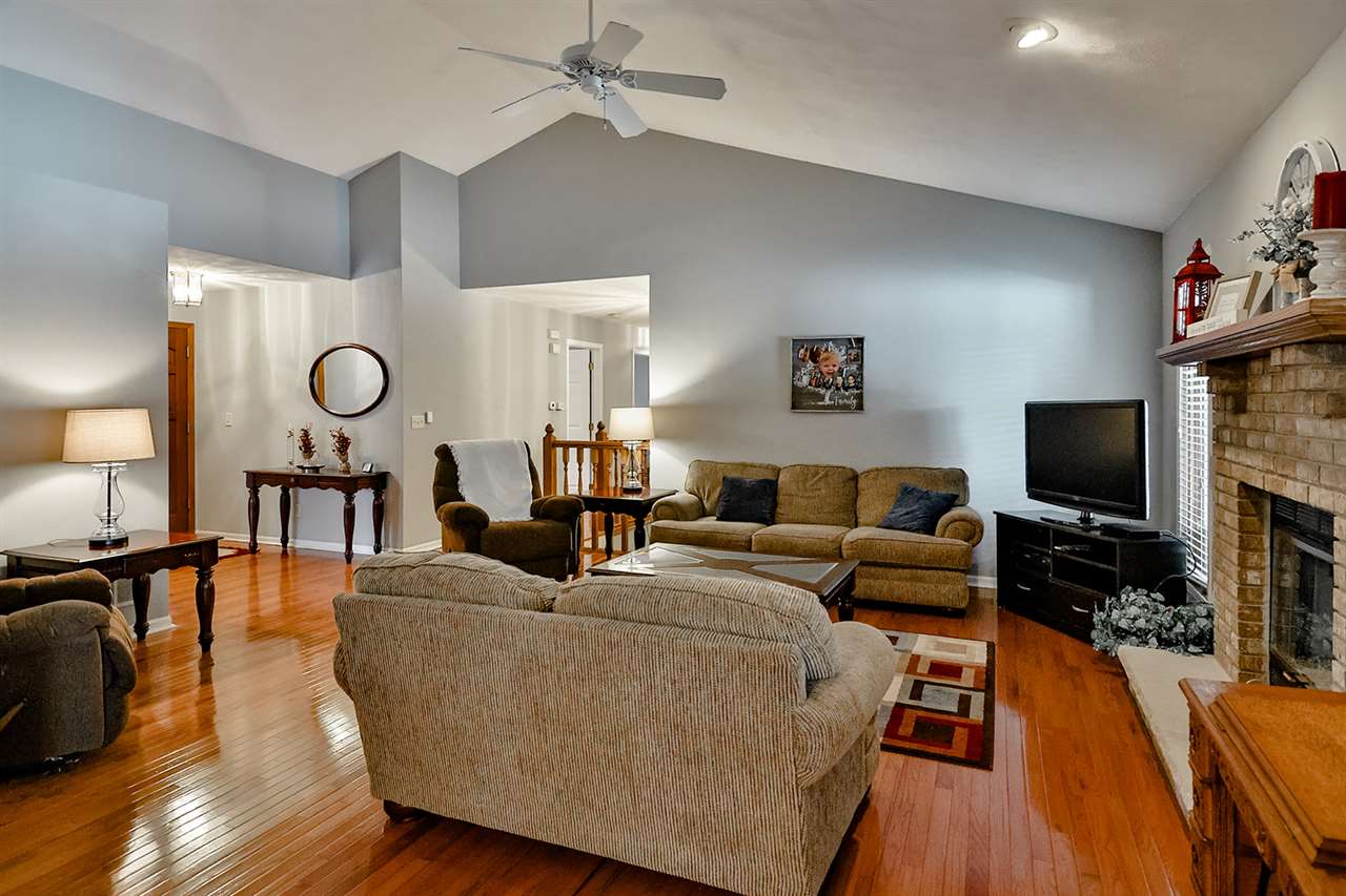 8112 McCurry Road Roscoe, IL 61073 - Photo 9 of 30 a living room with furniture and a flat screen tv