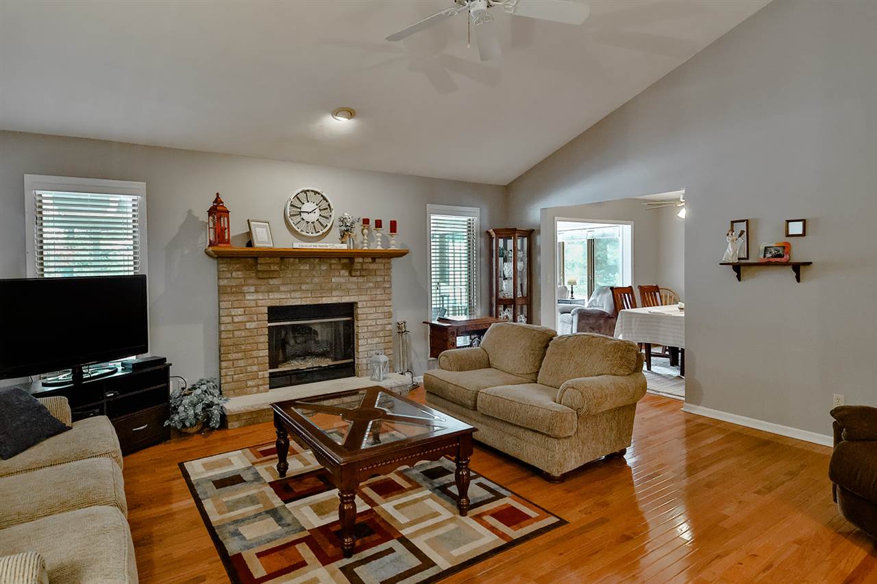 8112 McCurry Road Roscoe, IL 61073 - Photo 10 of 30 a living room with furniture a flat screen tv and a fireplace