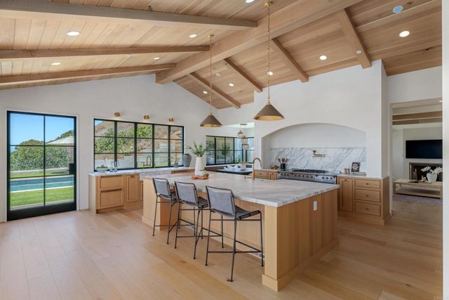 a large kitchen with a table and chairs