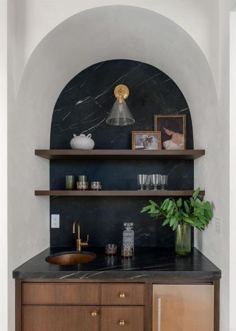 a front view of a fireplace with potted plant