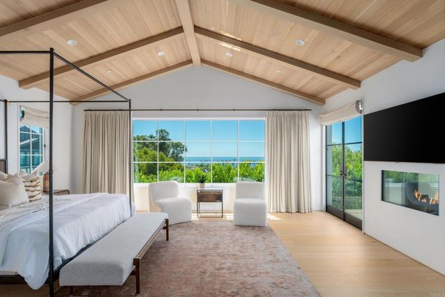 a living room with a couch a flat screen tv and a large window