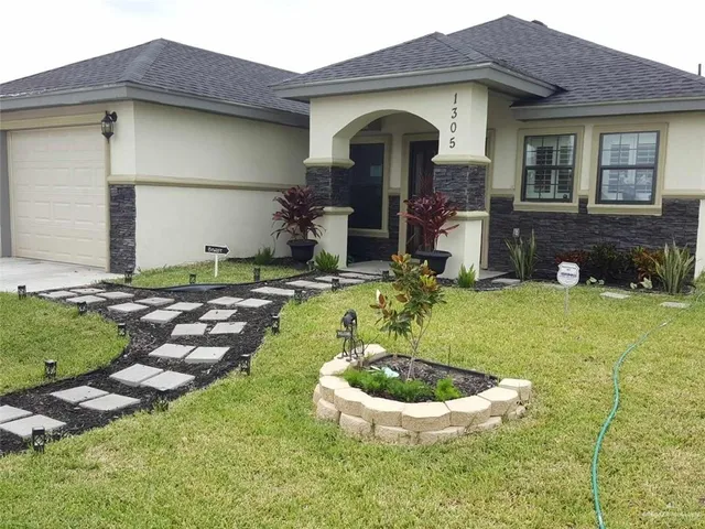 a view of a house with swimming pool and a yard