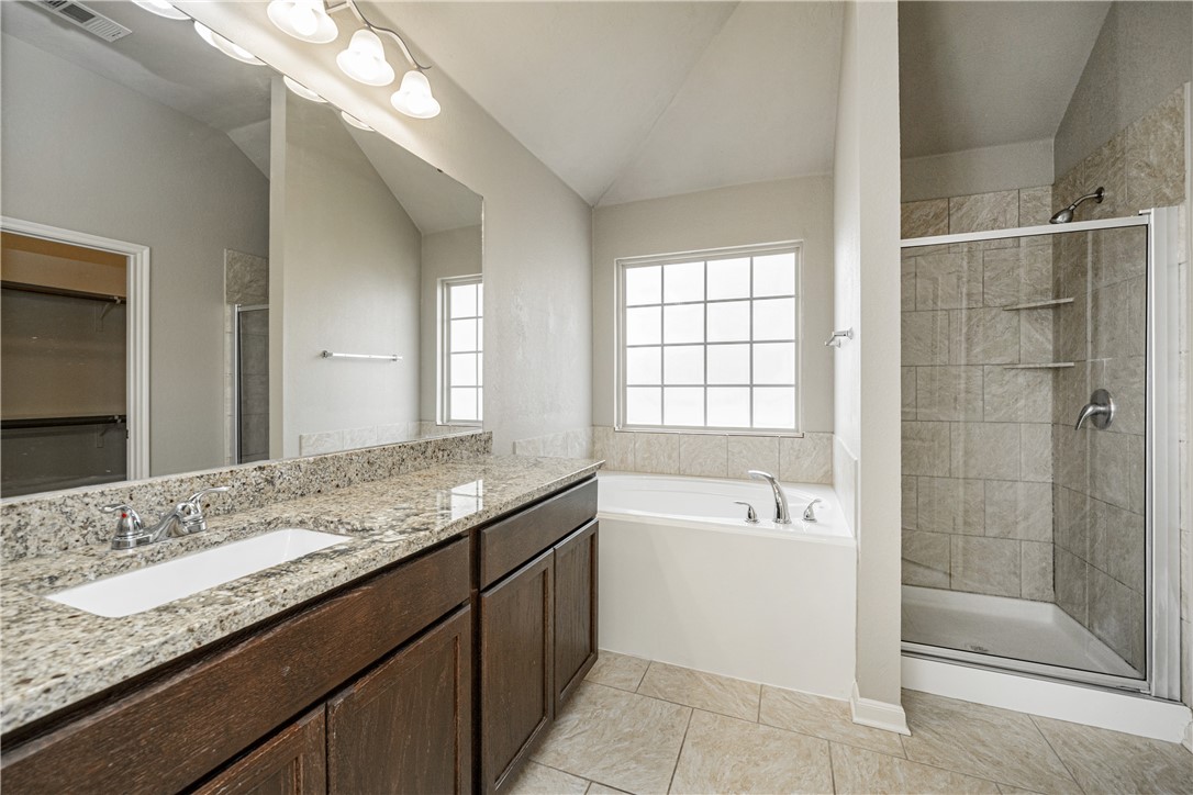 3009 Positano Loop Bryan, TX 77808 - Photo 13 of 21 a bathroom with a granite countertop sink mirror and bathtub