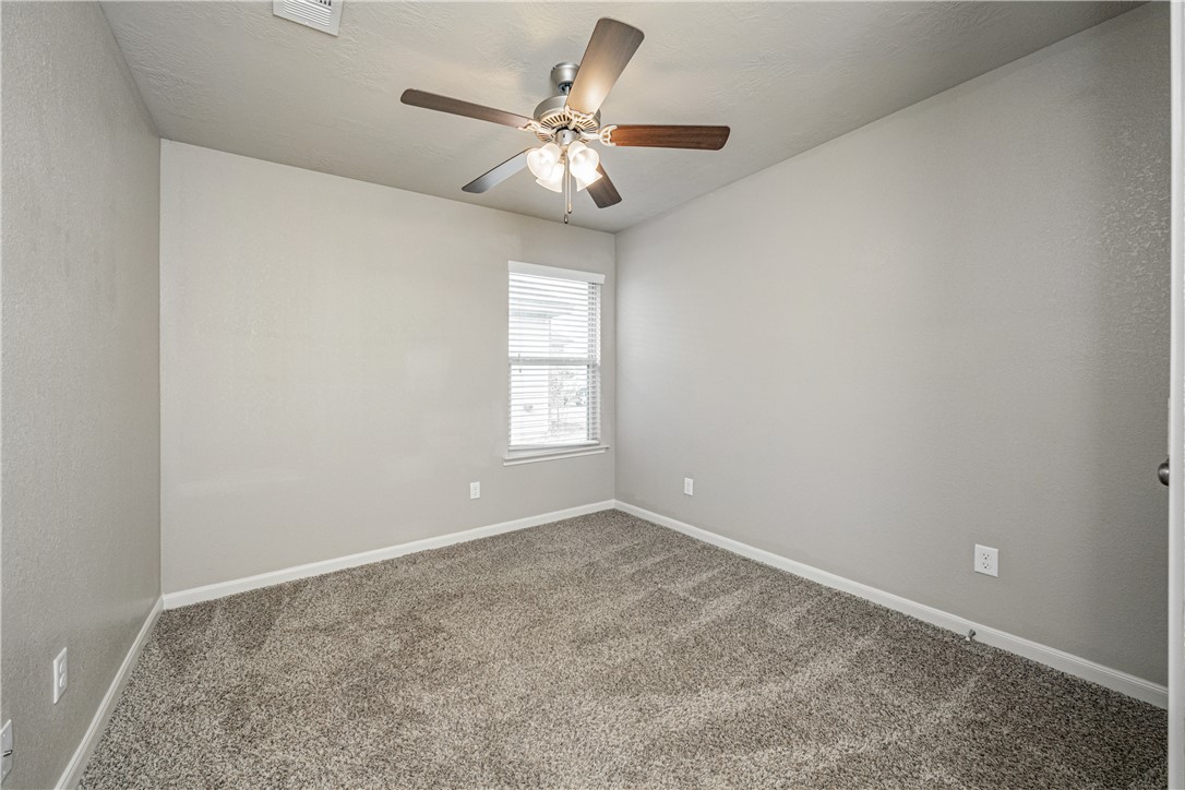 3009 Positano Loop Bryan, TX 77808 - Photo 15 of 21 an empty room with windows and fan