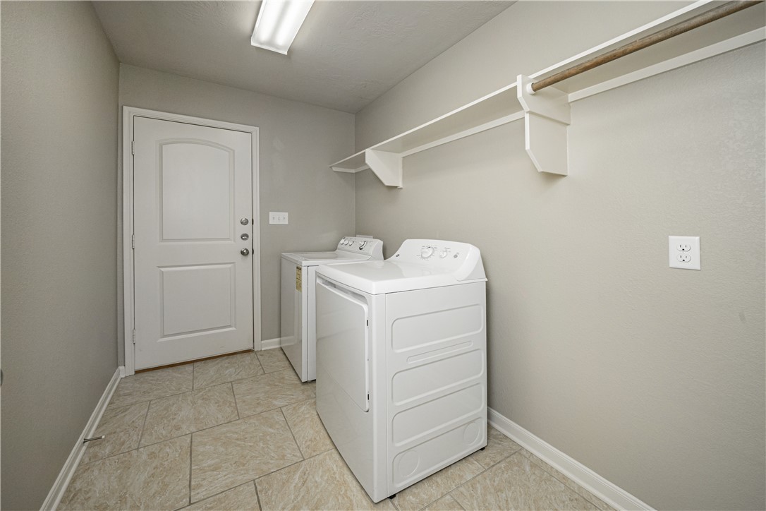 3009 Positano Loop Bryan, TX 77808 - Photo 19 of 21 a utility room with cabinets washer and dryer