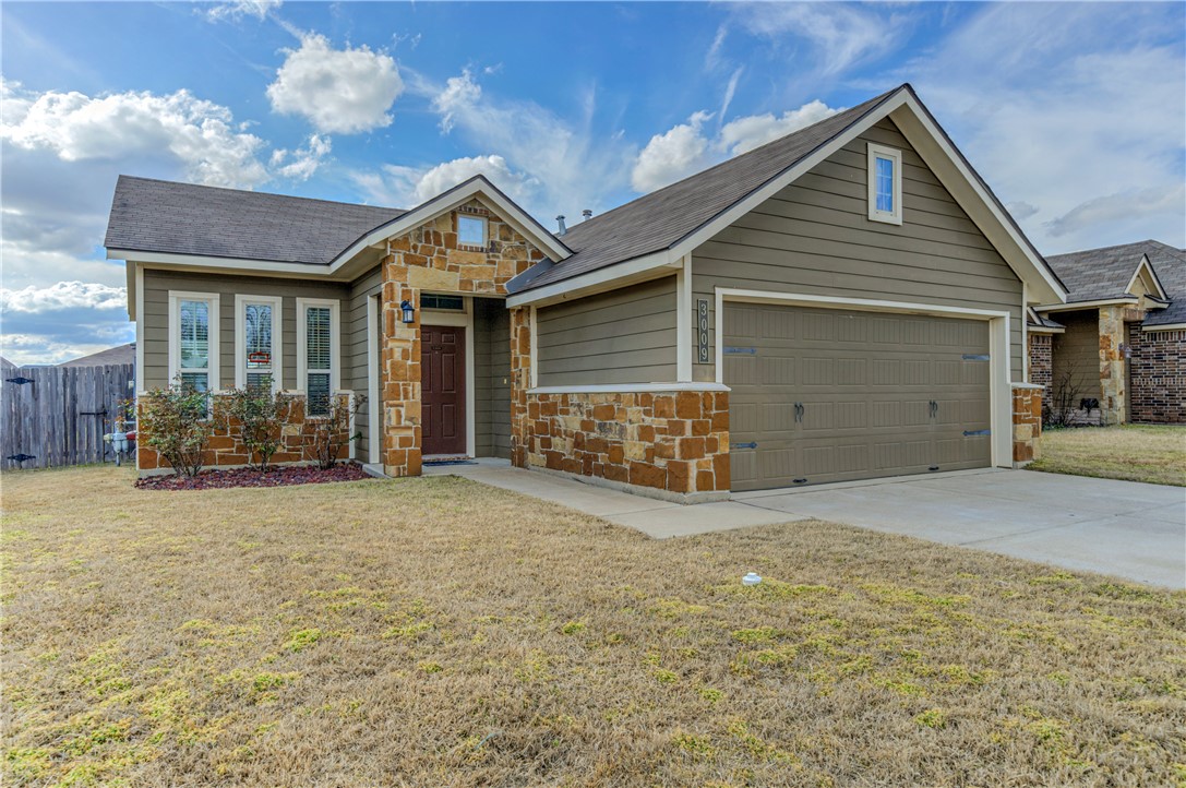 3009 Positano Loop Bryan, TX 77808 - Photo 2 of 21 a view of a house with a yard and garage