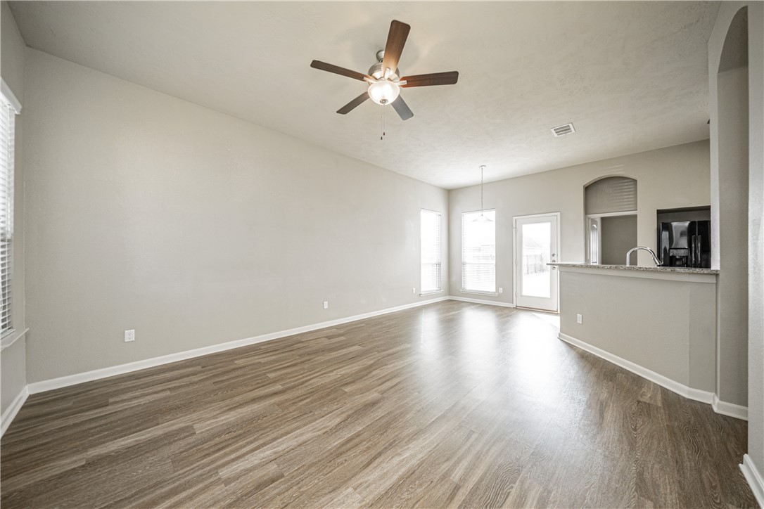 3009 Positano Loop Bryan, TX 77808 - Photo 5 of 21 wooden floor in an empty room with a window