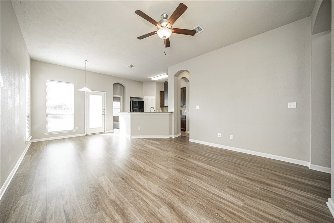3009 Positano Loop Bryan, TX 77808 - Photo 6 of 21 wooden floor in an empty room with a window