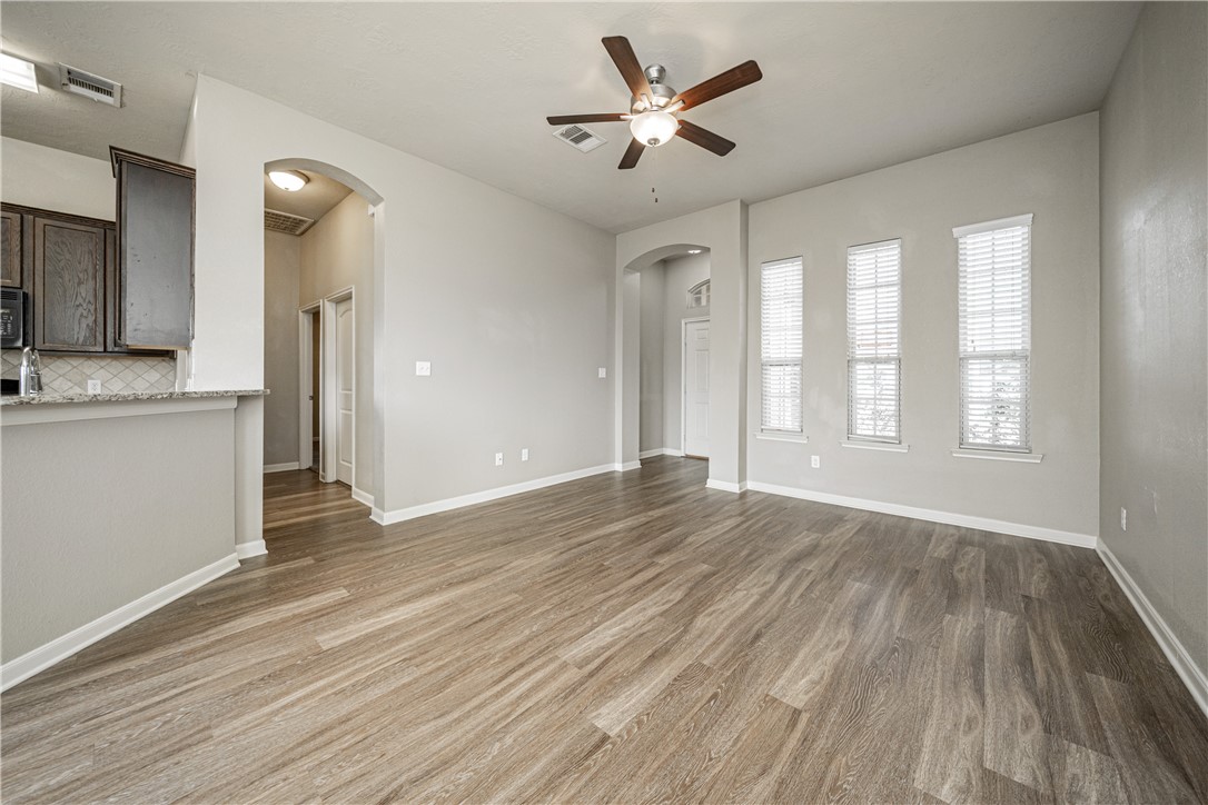 3009 Positano Loop Bryan, TX 77808 - Photo 7 of 21 wooden floor in an empty room with a window