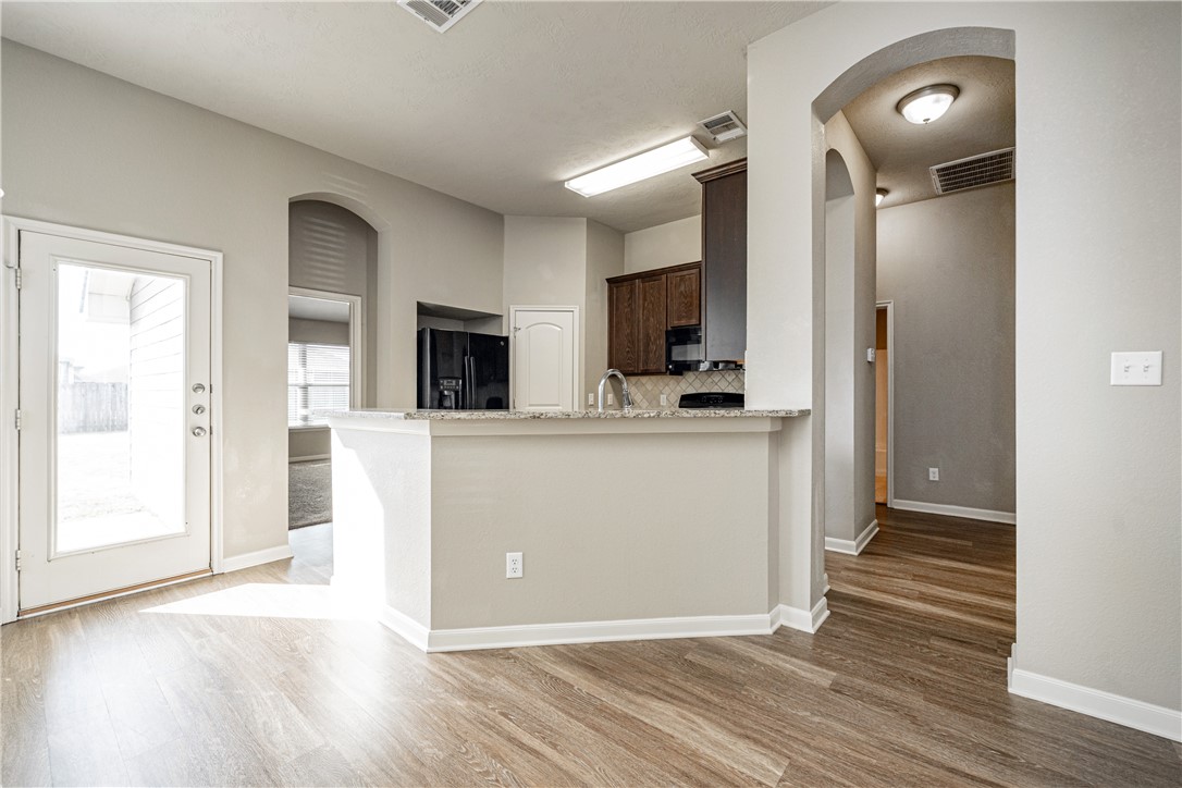 3009 Positano Loop Bryan, TX 77808 - Photo 8 of 21 a view of a kitchen cabinets and wooden floor