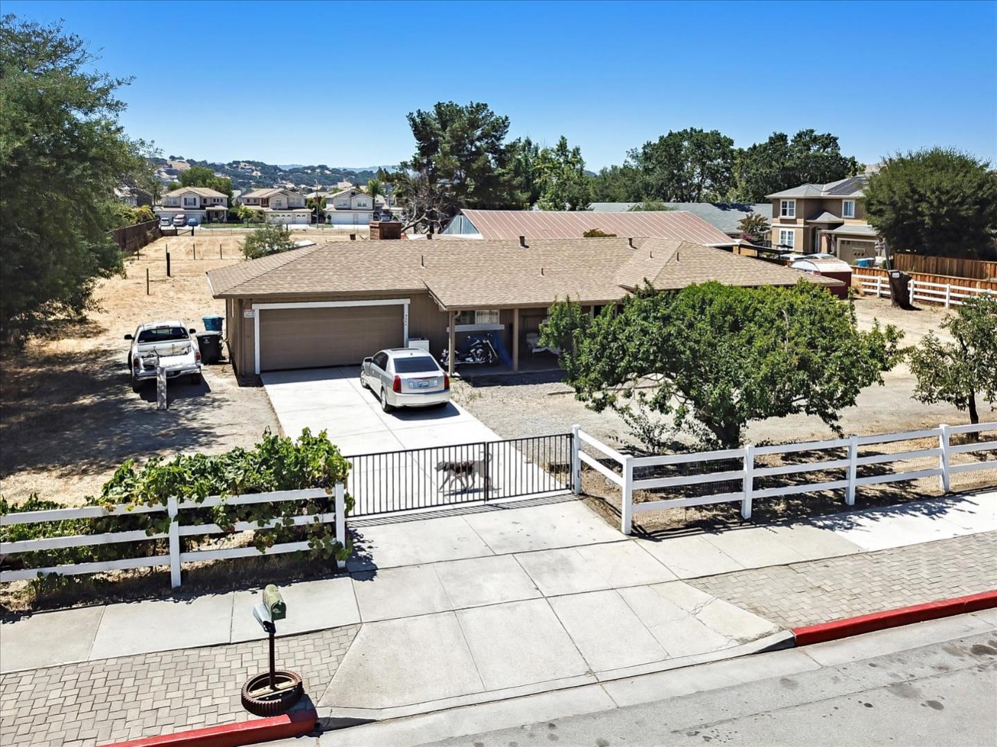 9045 Kern Avenue Gilroy, CA 95020 - Photo 2 of 14 a view of a patio with couches table and chairs under an umbrella