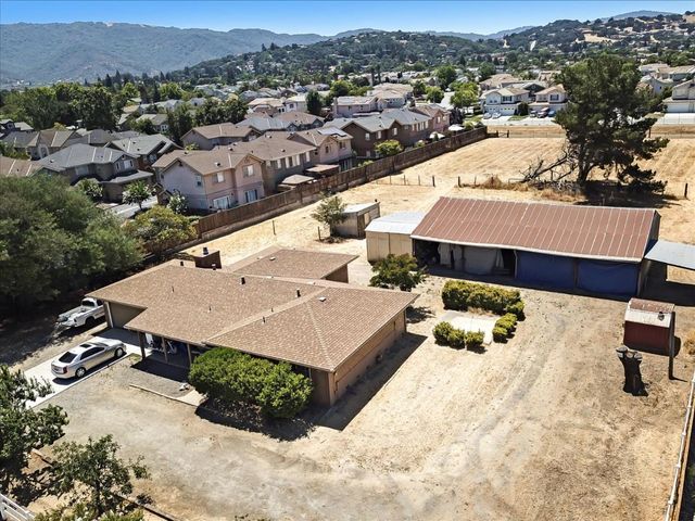 an aerial view of a house with a yard