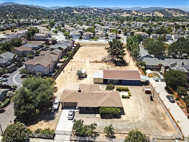 an aerial view of residential houses with outdoor space