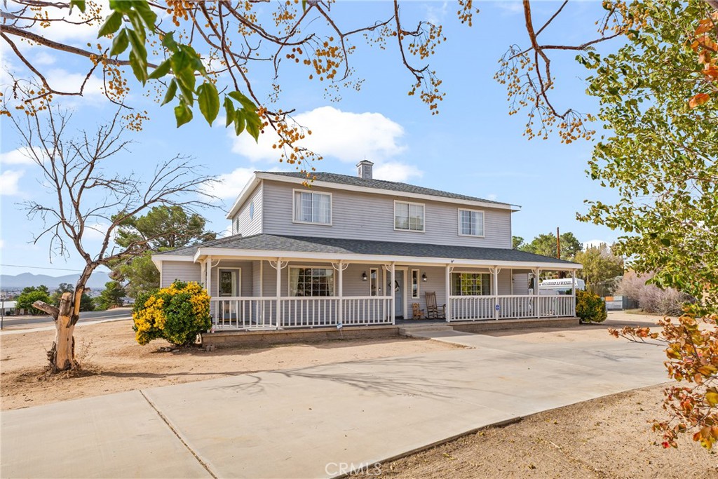a front view of a house with a tree
