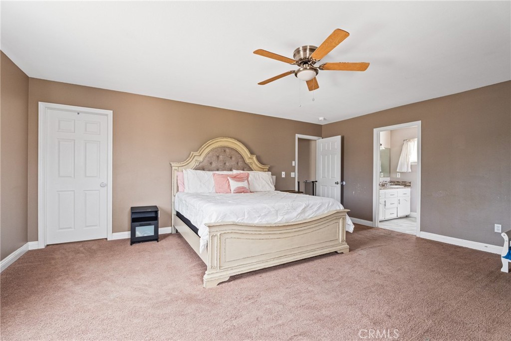 14610 Apple Valley Road Apple Valley, CA 92307 - Photo 29 of 49 a spacious bedroom with a bed and window