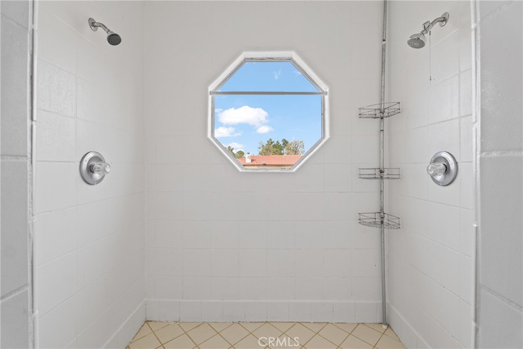 14610 Apple Valley Road Apple Valley, CA 92307 - Photo 32 of 49 a bathroom with a mirror and a shower