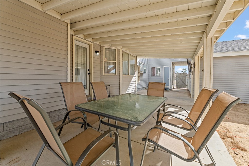 14610 Apple Valley Road Apple Valley, CA 92307 - Photo 37 of 49 a view of a patio with table and chairs and potted plants
