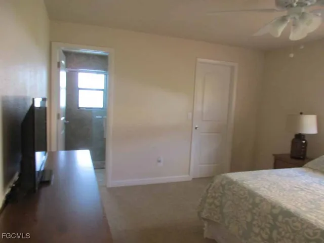 a bedroom with a bed and a view of bedroom