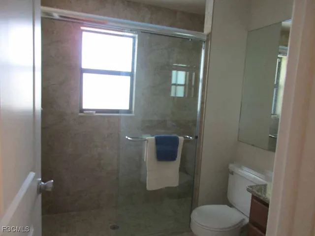 a bathroom with a toilet and a shower