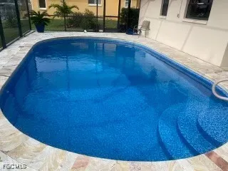 a view of kitchen and hall with wooden floor