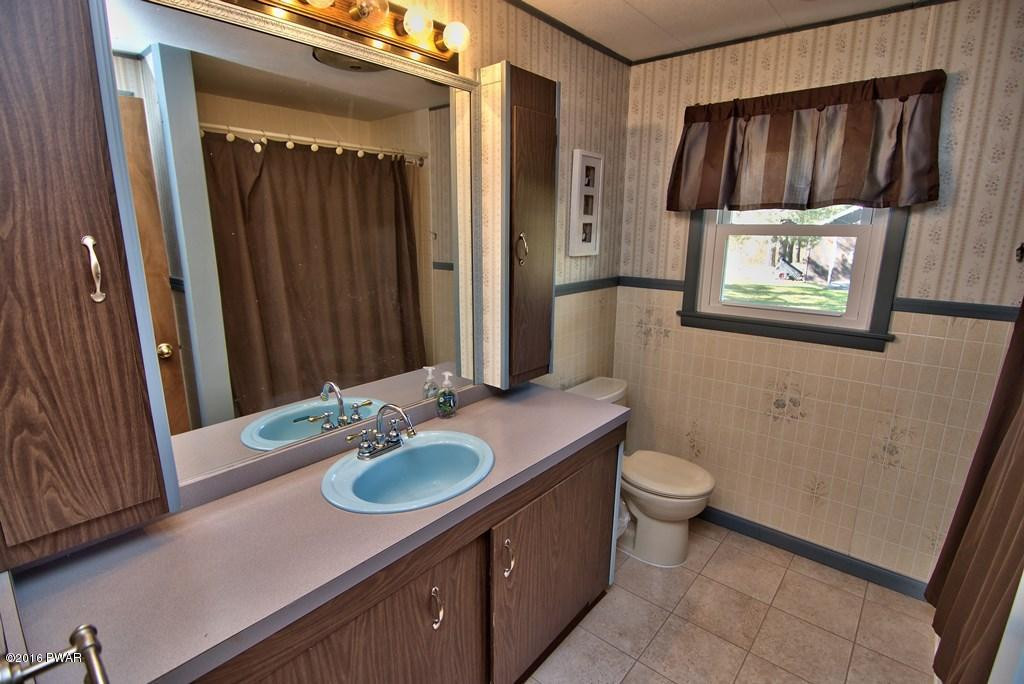 3321 Aberdeen Road Moscow, PA 18444 - Photo 13 of 20 a bathroom with a sink a toilet and shower