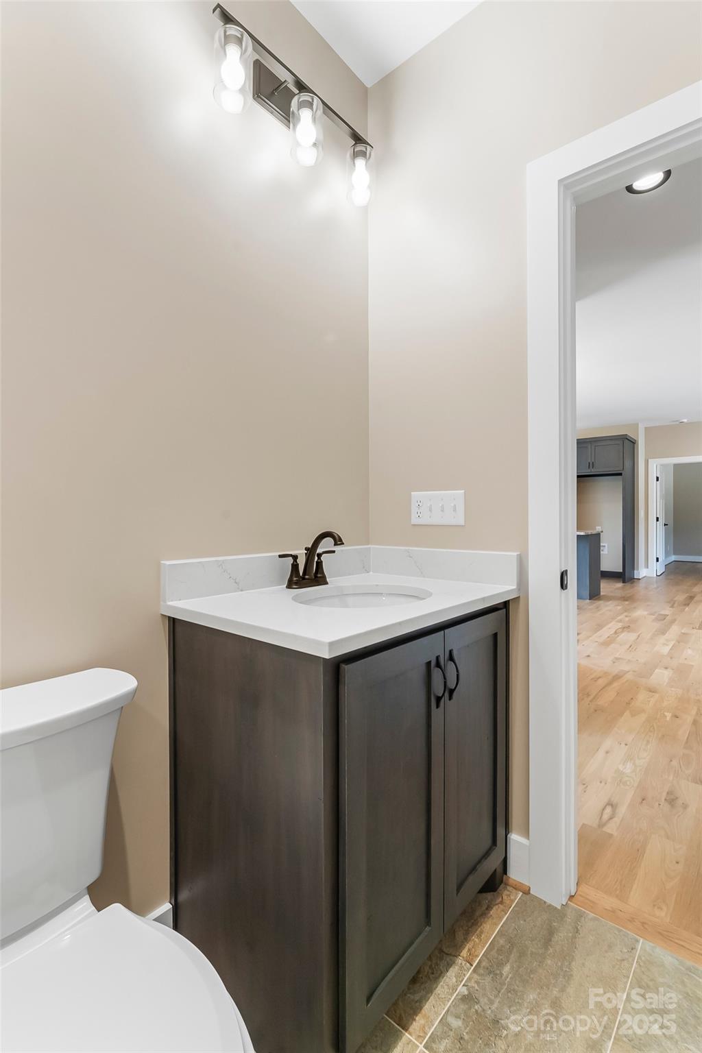 2937 Frank Whisnant Road Morganton, NC 28655 - Photo 15 of 25 a bathroom with a sink vanity and a toilet