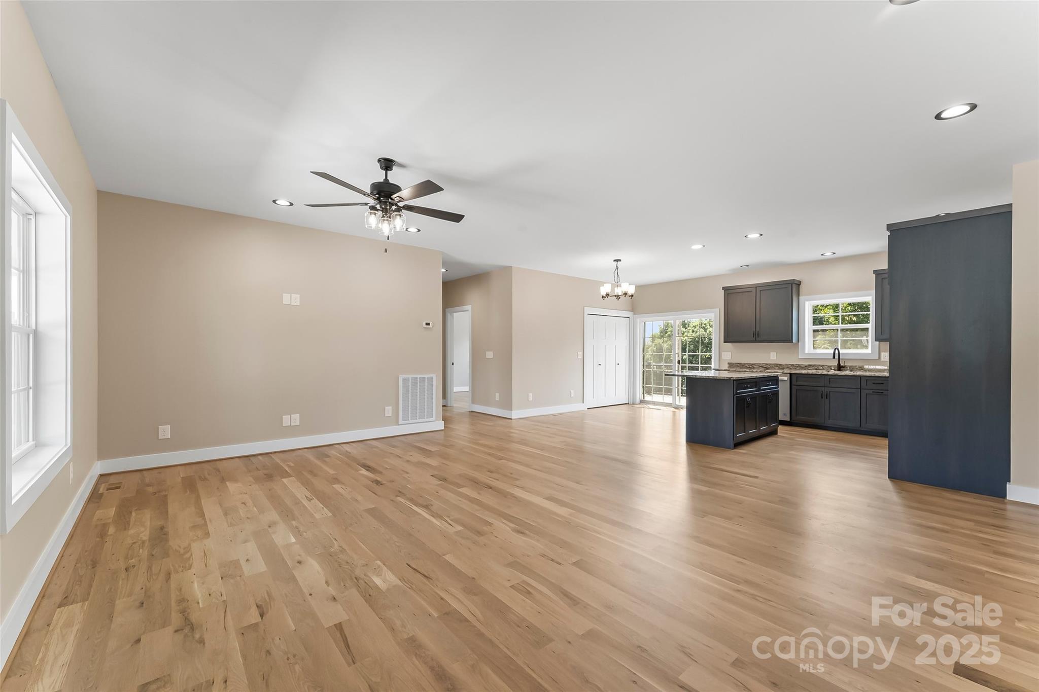 2937 Frank Whisnant Road Morganton, NC 28655 - Photo 8 of 25 a view of an empty room with a kitchen and wooden floor