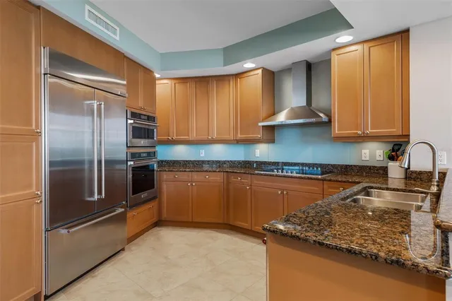 a large kitchen with a table and chairs