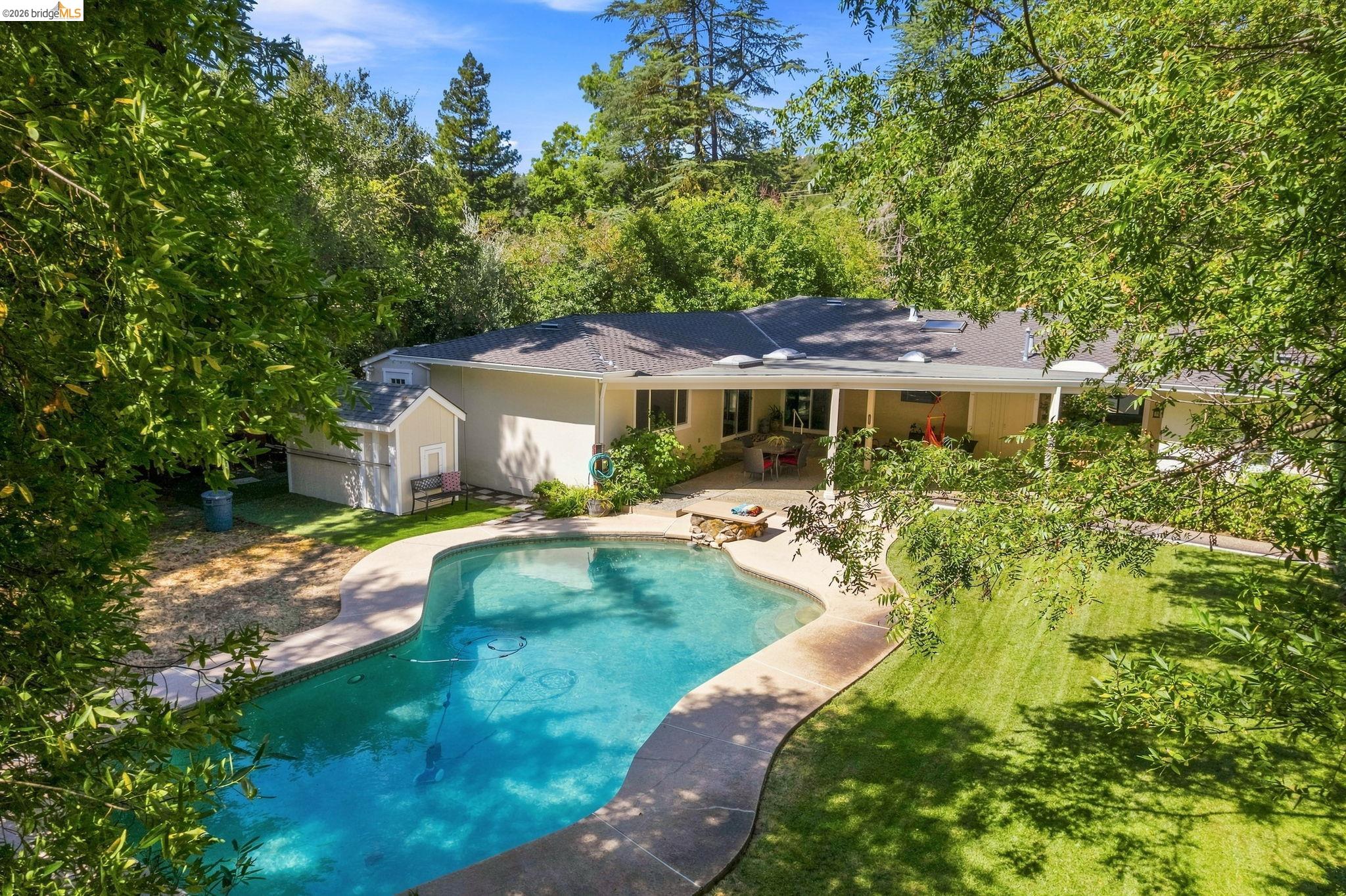 5075 Alhambra Valley Road Martinez, CA 94553 - Photo 60 of 68 Curved-edge swimming pool with surrounding concrete decking