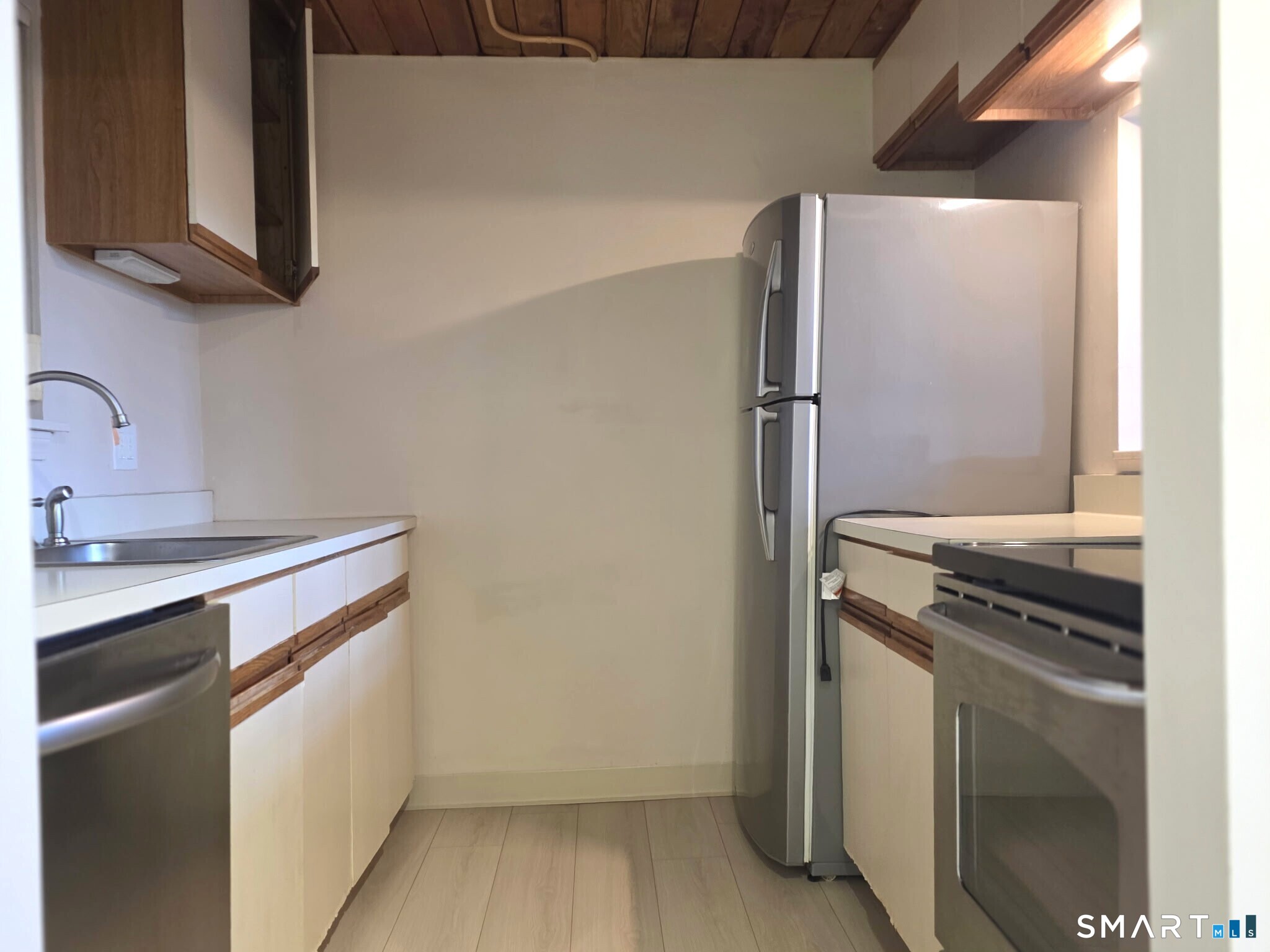 839 Main Street, Unit 91 Torrington, CT 06790 - Photo 5 of 14 a kitchen with a stove and a refrigerator