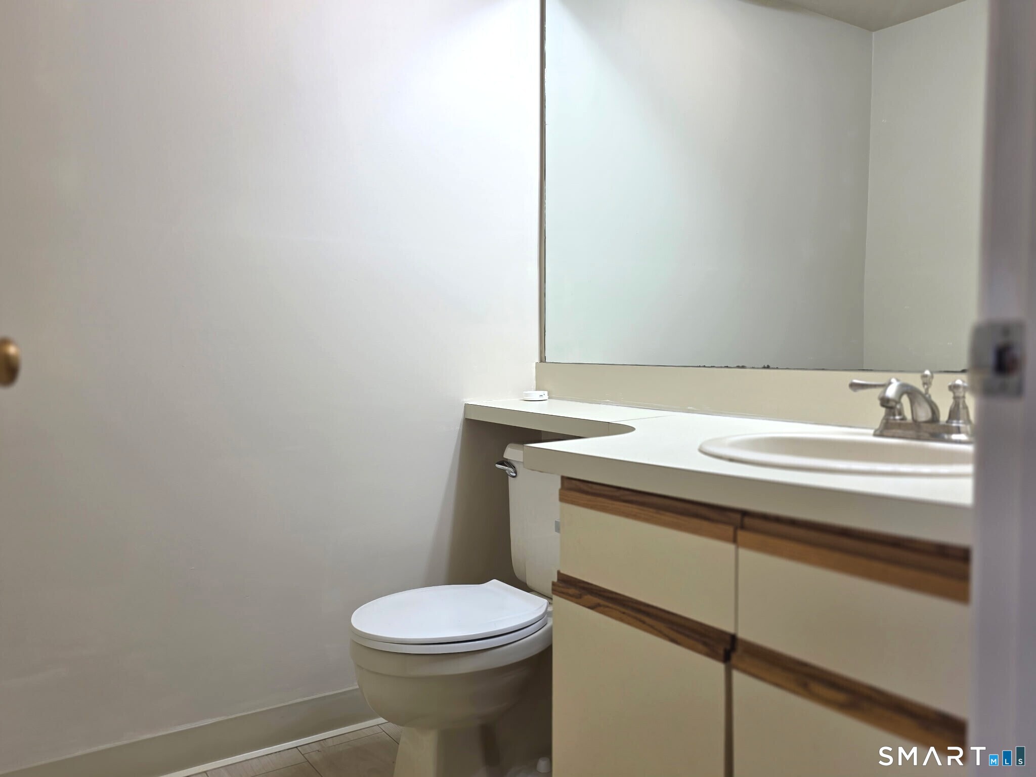 839 Main Street, Unit 91 Torrington, CT 06790 - Photo 7 of 14 a bathroom with a sink a toilet and a mirror