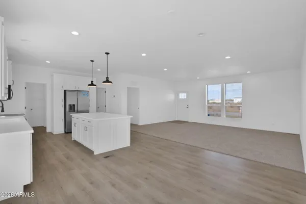 a view of a kitchen with a sink and a refrigerator