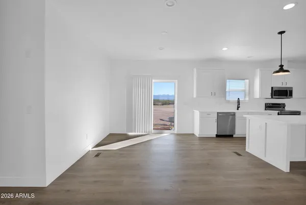 a view of kitchen with kitchen island and stainless steel appliances